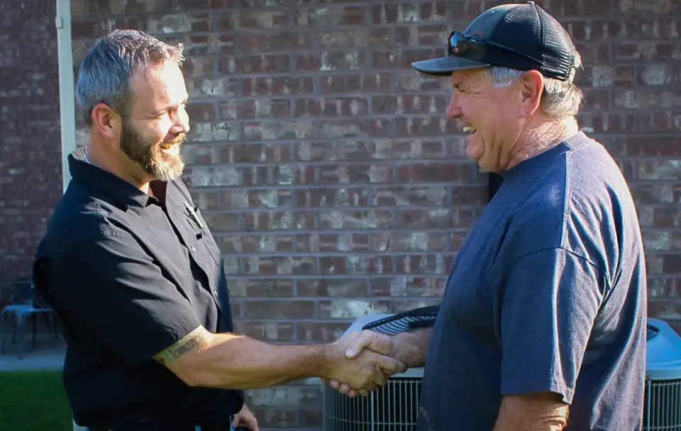 Founder, owner and operator Steven Sherrell shakes the hand of one of his valued customers after an HVAC inspection.